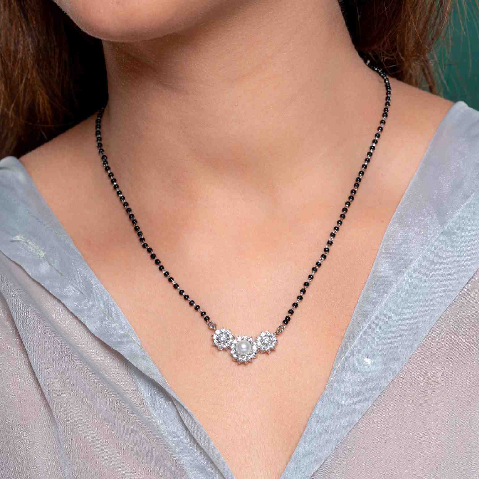 A beautiful 925 silver jewelry set consisting of a mangalsutra-style necklace and a pair of stud earrings.